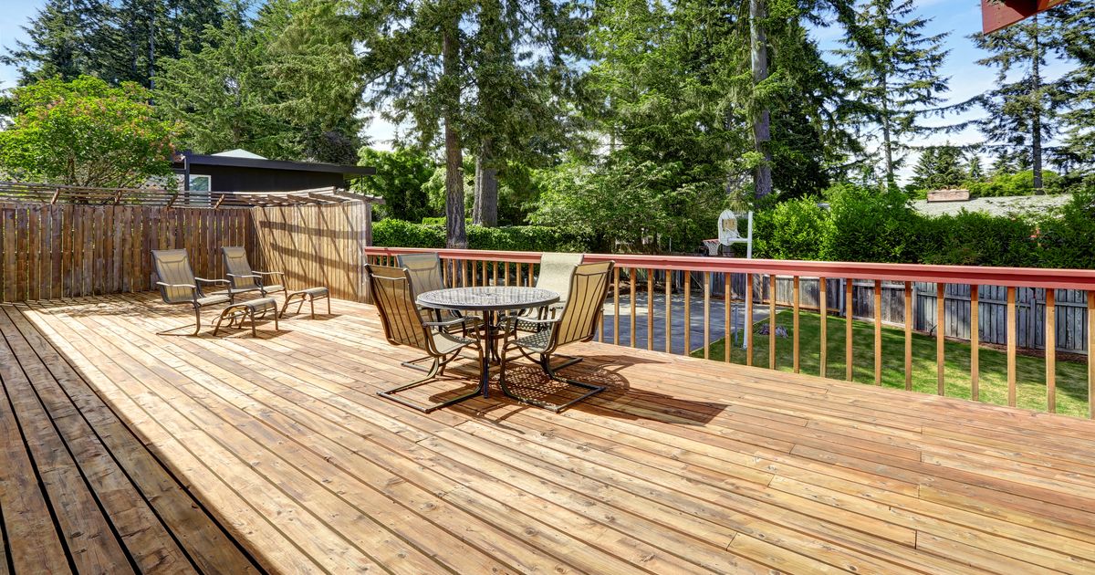 Spacious wooden deck with patio table set.