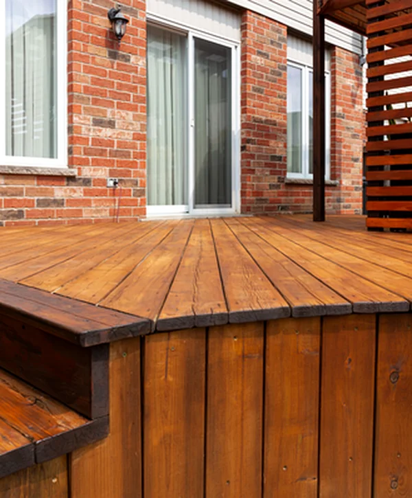 deck staining painting lawrence in deck building professional deck with rich brown stain featuring expert craftsmanship and polished wood