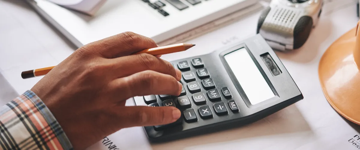 a person using a calculator for calculating deck load for a deck building project